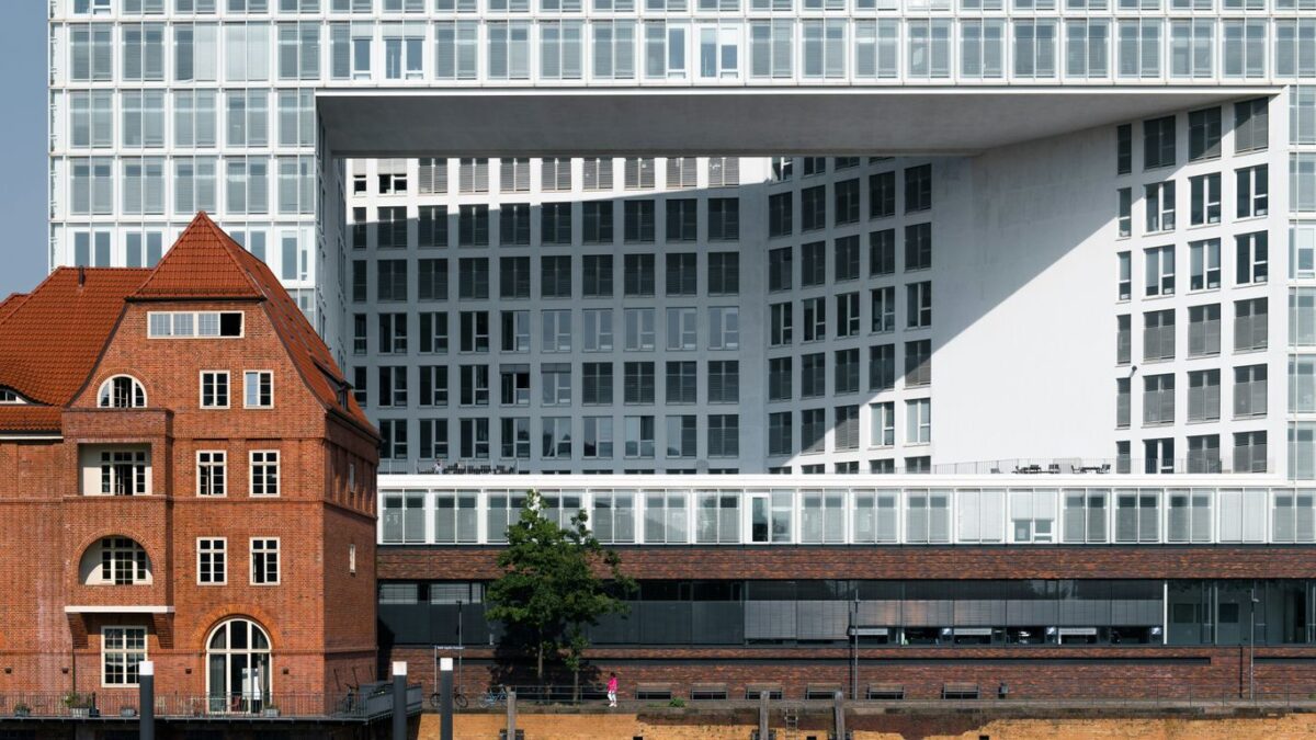 A large white building sitting next to a body of water