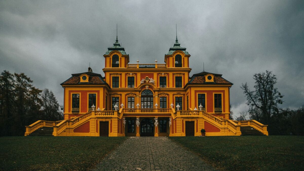 a large yellow building with two towers on top of it