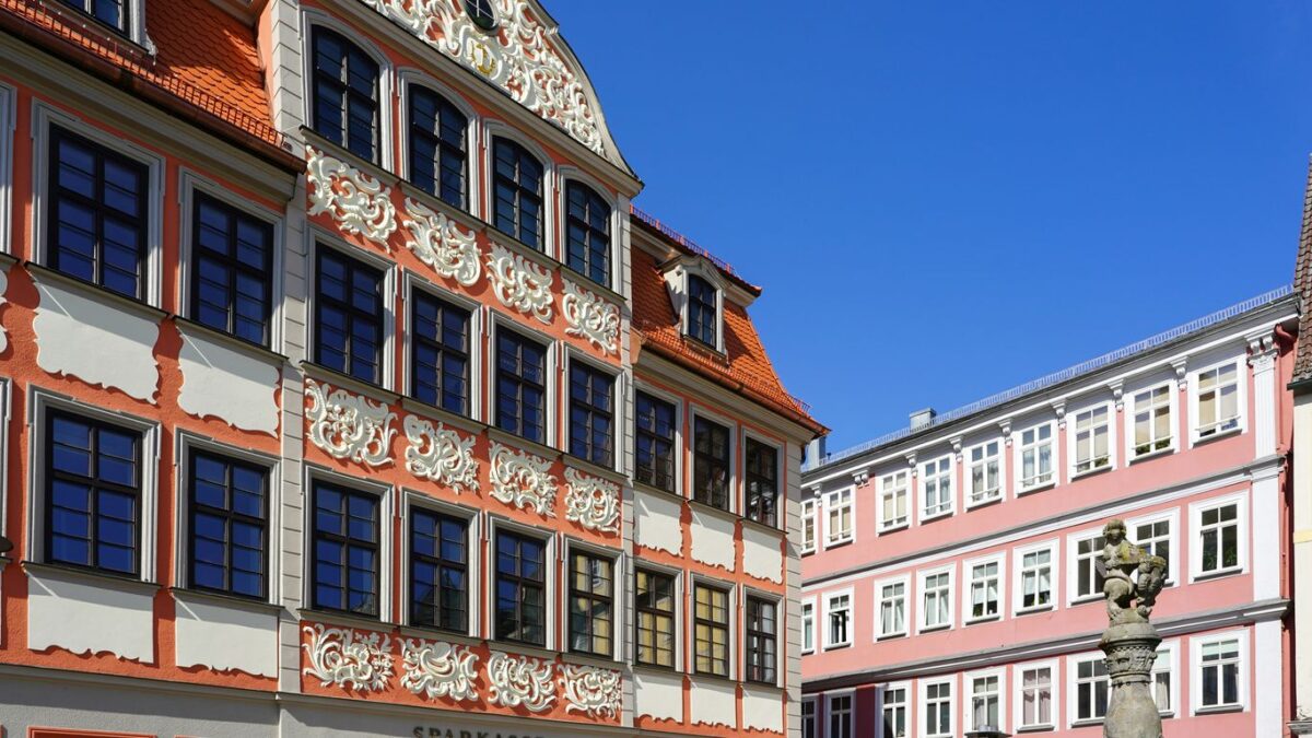 Historic buildings stand tall under a bright sky.
