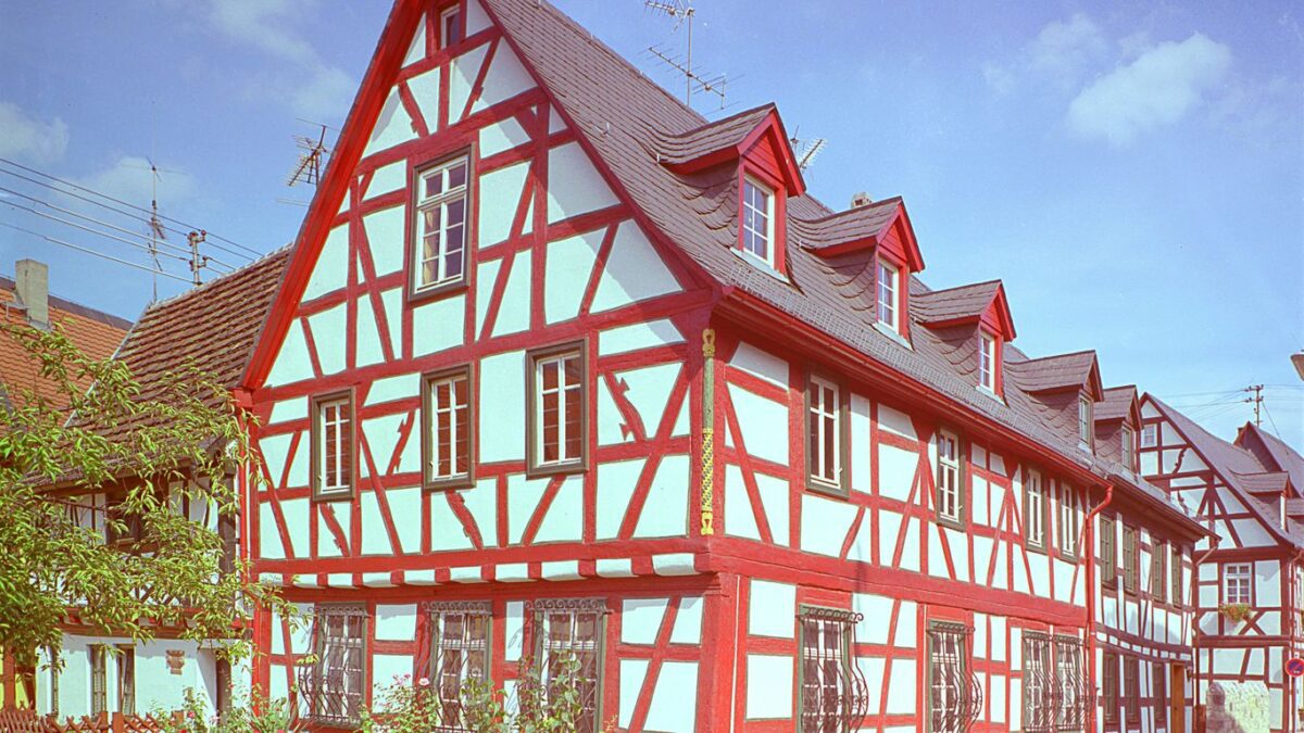 a red and white building with a red roof