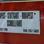 Sign on red bus lists destinations and phone numbers