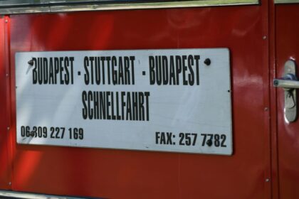 Sign on red bus lists destinations and phone numbers