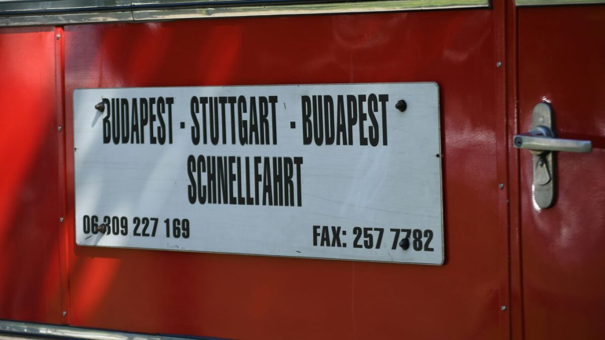 Sign on red bus lists destinations and phone numbers