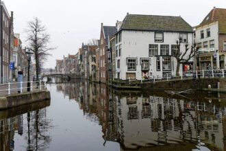 Canal lined with buildings and reflections in water.