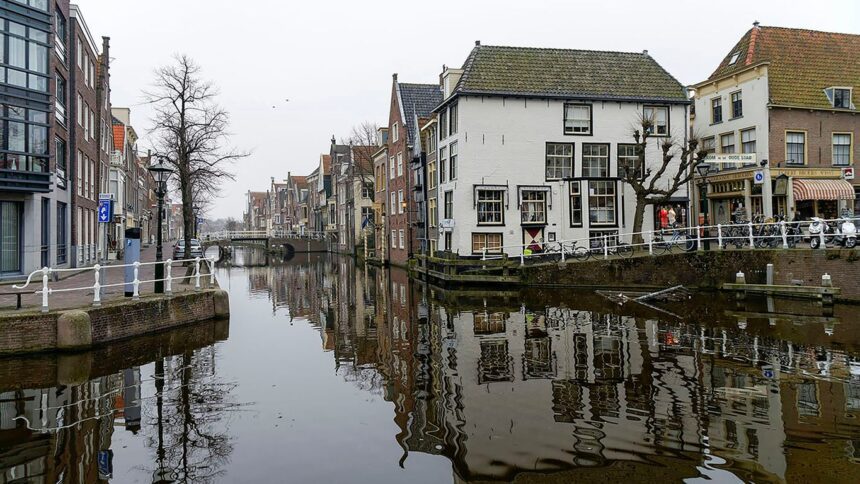 Canal lined with buildings and reflections in water.