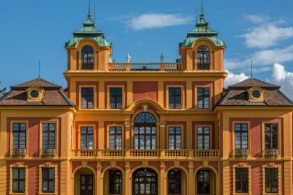 a large orange and yellow building with two towers