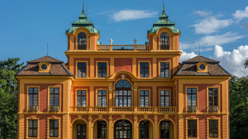 a large orange and yellow building with two towers
