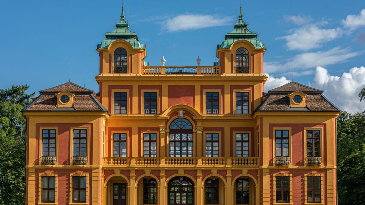 a large orange and yellow building with two towers