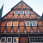 A tall building with lots of windows next to other buildings