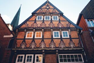 A tall building with lots of windows next to other buildings