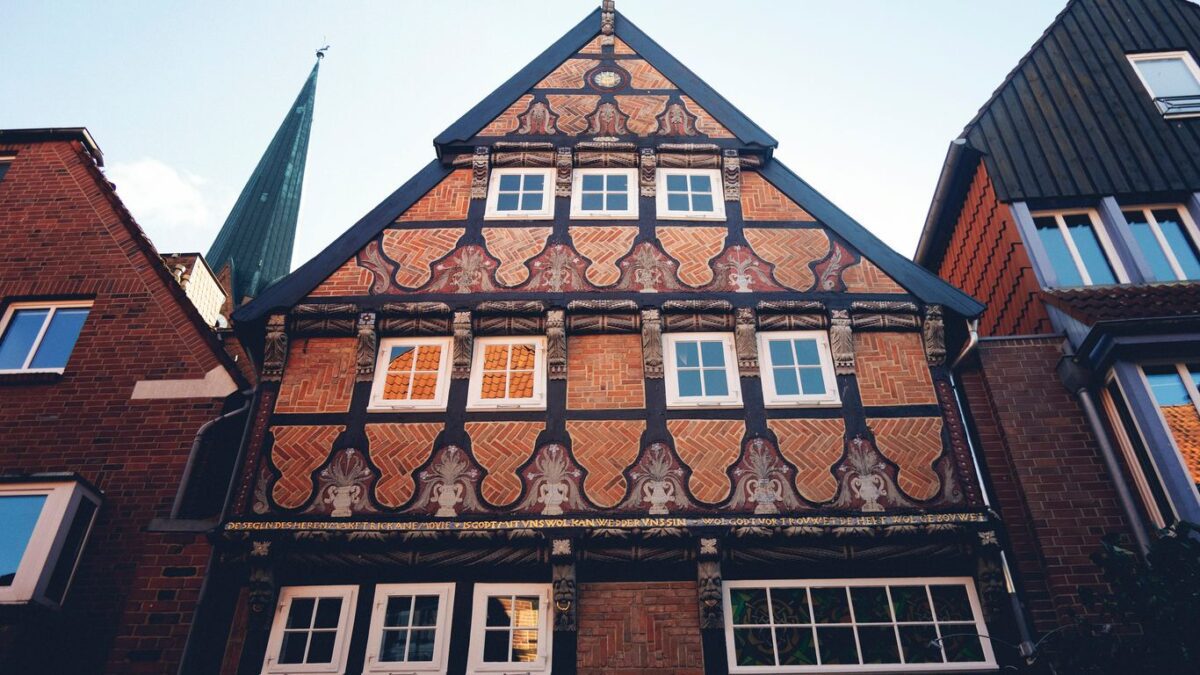 A tall building with lots of windows next to other buildings