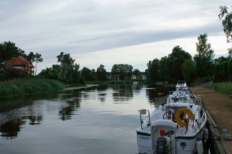 a boat is docked at a dock on the water